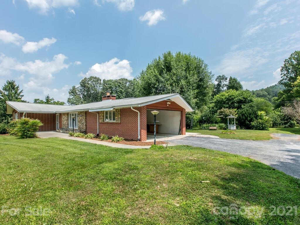 2044 Ridge Road Hendersonville, NC 28792 - Photo 3 of 37 a front view of a house with garden