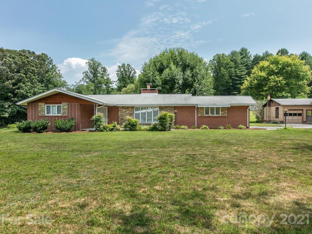 2044 Ridge Road Hendersonville, NC 28792 - Photo 5 of 37 a front view of house with a garden