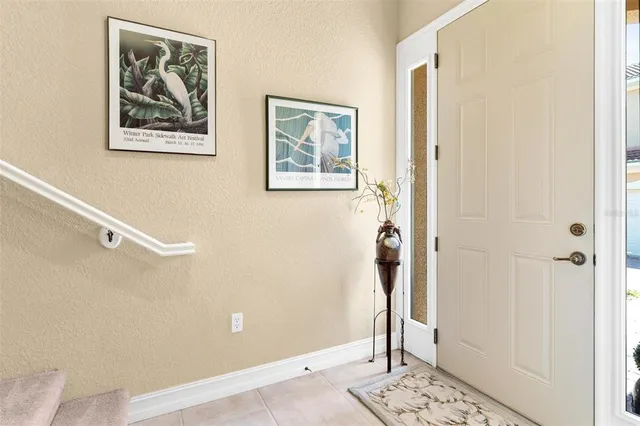 a view of a hallway with wooden floor and windows
