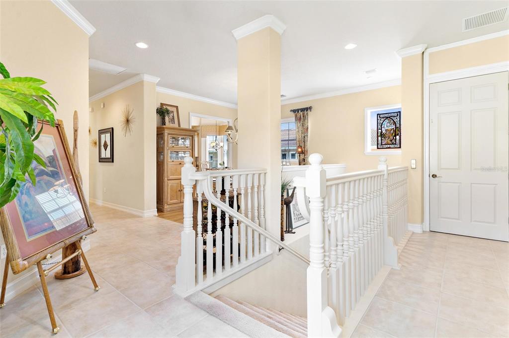 26142 Avenida Las Colinas, Unit 2B Howey-in-the-Hills, FL 34737 - Photo 14 of 78 a view of a hallway with wooden floor and windows