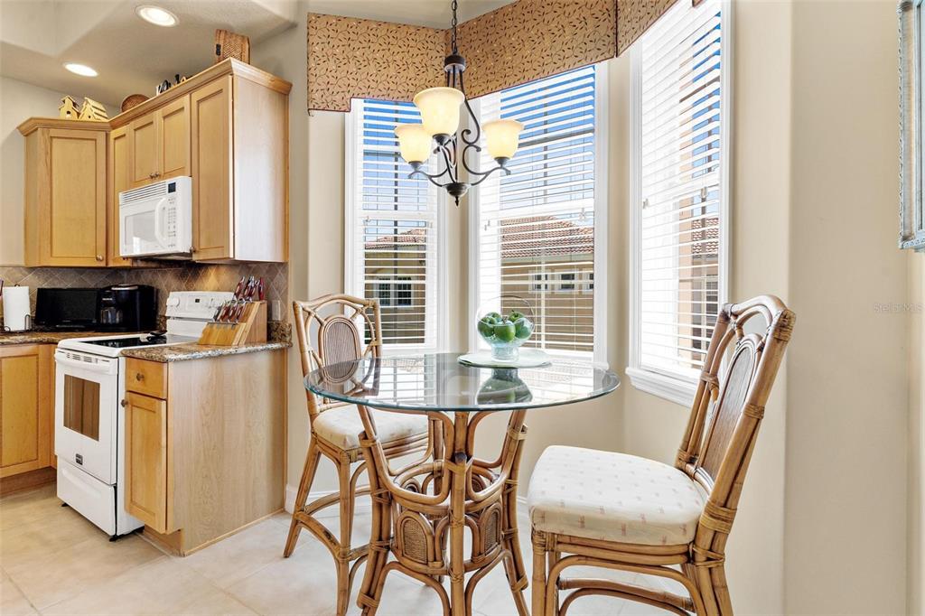 26142 Avenida Las Colinas, Unit 2B Howey-in-the-Hills, FL 34737 - Photo 29 of 78 a view of a dining room with furniture and a chandelier