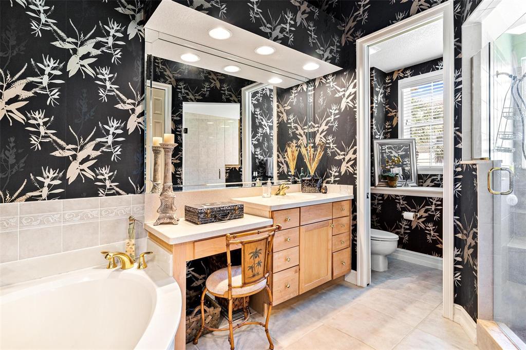 26142 Avenida Las Colinas, Unit 2B Howey-in-the-Hills, FL 34737 - Photo 43 of 78 a bathroom with a tub sink and mirror