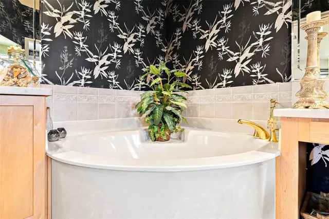 an aerial view of a houses with outdoor space swimming pool