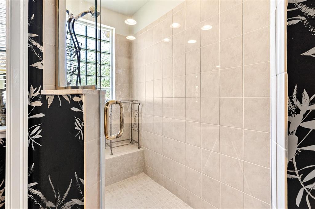 26142 Avenida Las Colinas, Unit 2B Howey-in-the-Hills, FL 34737 - Photo 47 of 78 a bathroom with a bathtub and shower