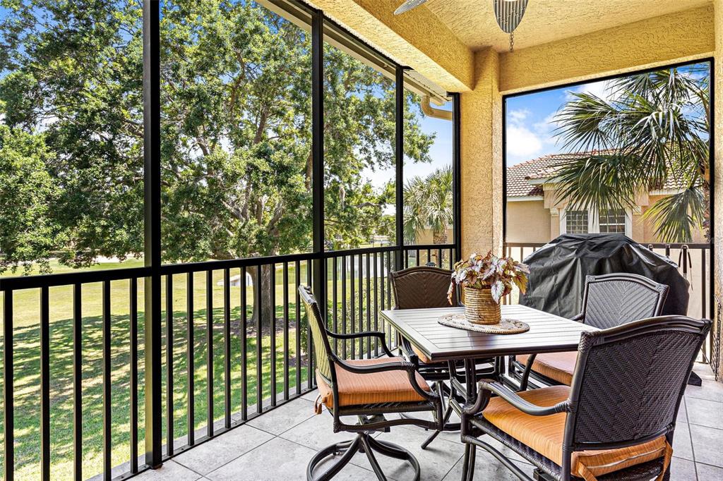 26142 Avenida Las Colinas, Unit 2B Howey-in-the-Hills, FL 34737 - Photo 55 of 78 a view of a chairs and table in the balcony