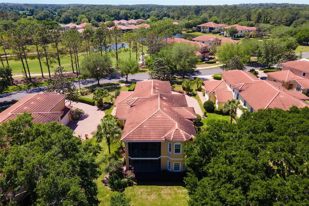 26142 Avenida Las Colinas, Unit 2B Howey-in-the-Hills, FL 34737 - Photo 57 of 78 an aerial view of multiple houses with yard