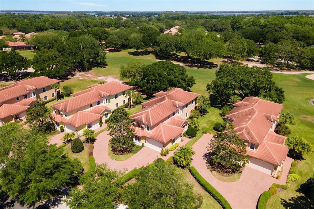 26142 Avenida Las Colinas, Unit 2B Howey-in-the-Hills, FL 34737 - Photo 61 of 78 an aerial view of lake residential house with swimming pool and outdoor space