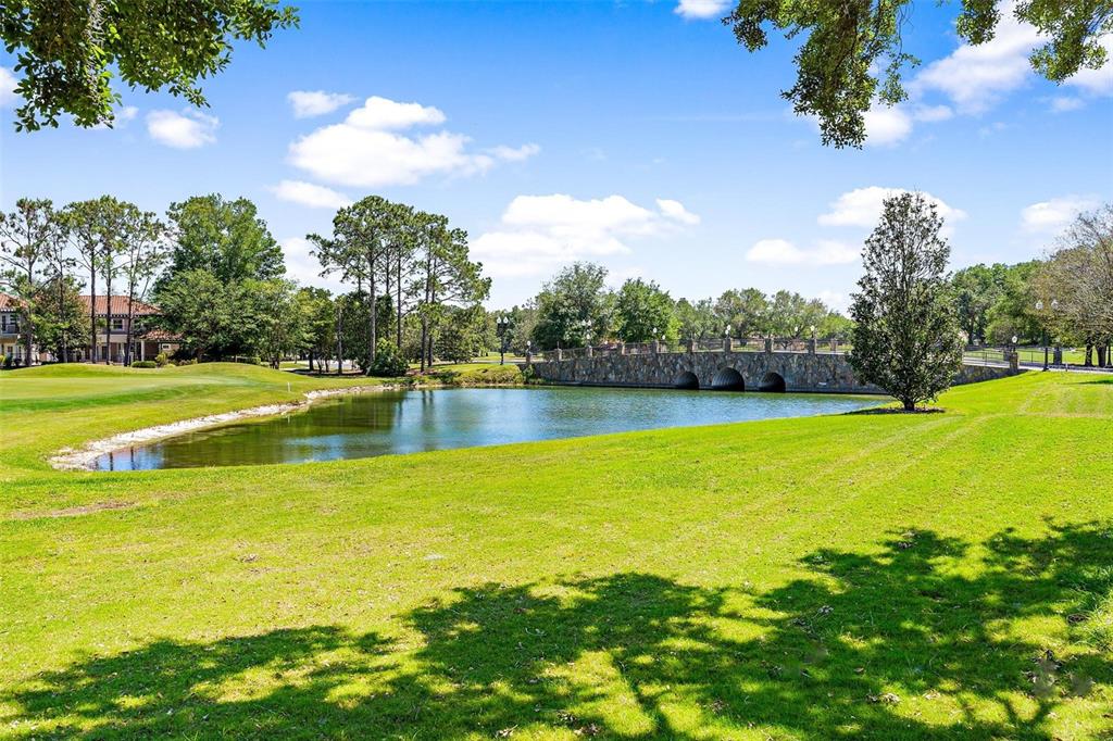 26142 Avenida Las Colinas, Unit 2B Howey-in-the-Hills, FL 34737 - Photo 7 of 78 a view of a swimming pool with an outdoor space and seating area