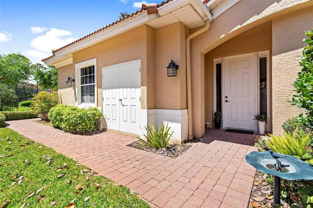 a view of a hallway with wooden floor and a potted plant