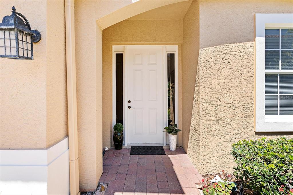 26142 Avenida Las Colinas, Unit 2B Howey-in-the-Hills, FL 34737 - Photo 10 of 78 a view of a hallway with wooden floor and a potted plant