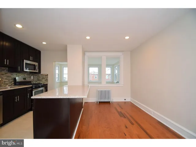 a open kitchen with kitchen island a sink window and stainless steel appliances