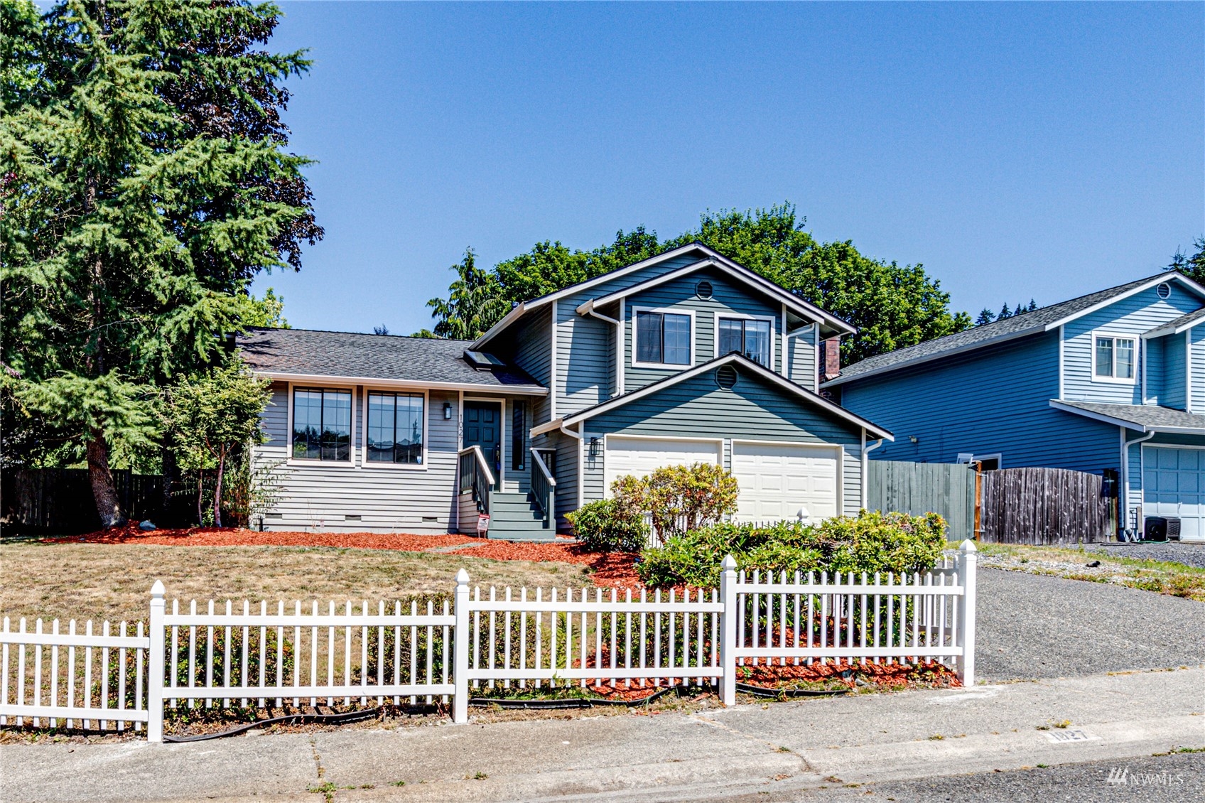 1027 233rd Place Southwest Bothell, WA 98021 - Photo 1 of 27 a front view of a house with a garden