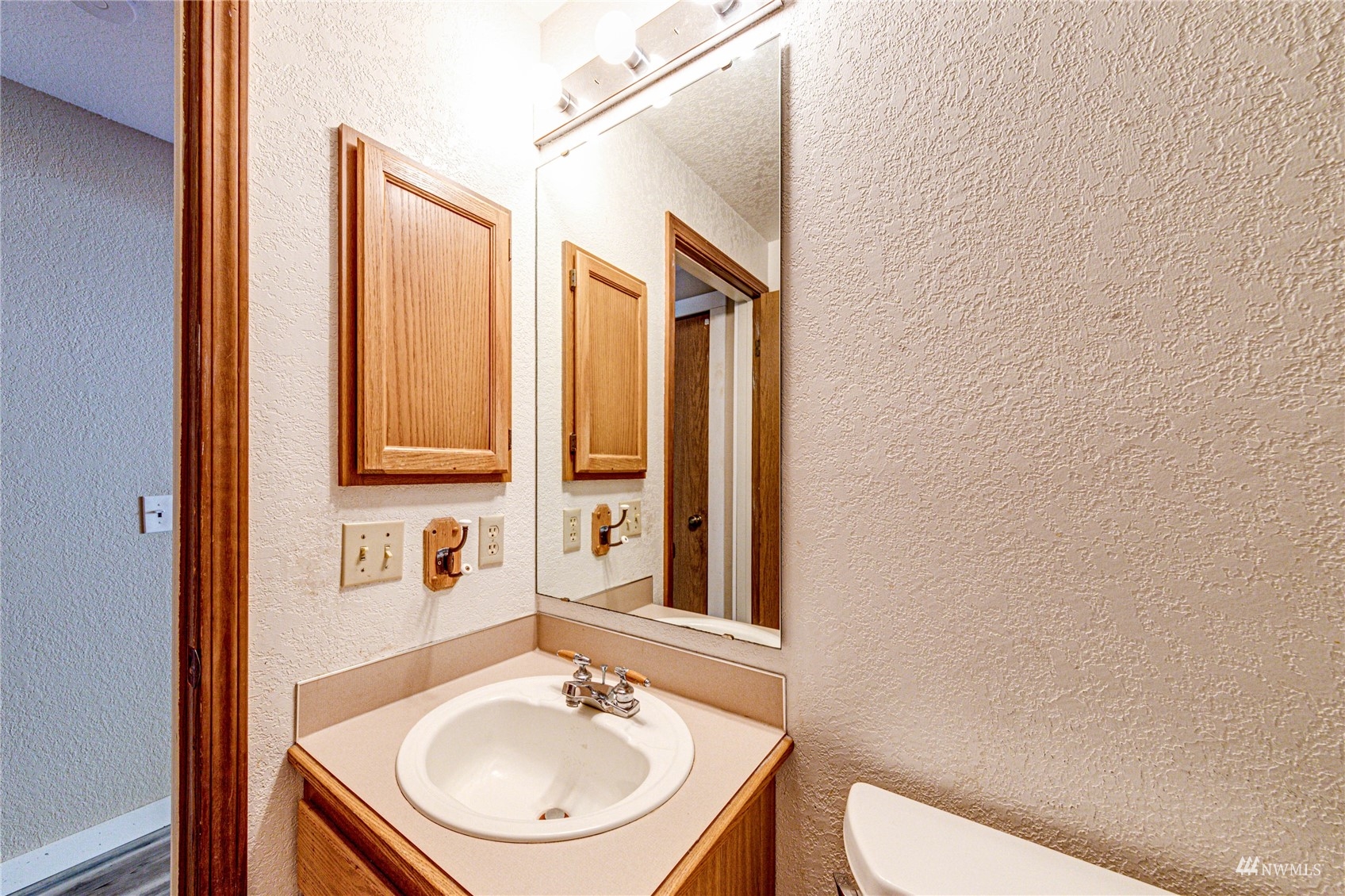 1027 233rd Place Southwest Bothell, WA 98021 - Photo 13 of 27 a bathroom with a sink a toilet and mirror
