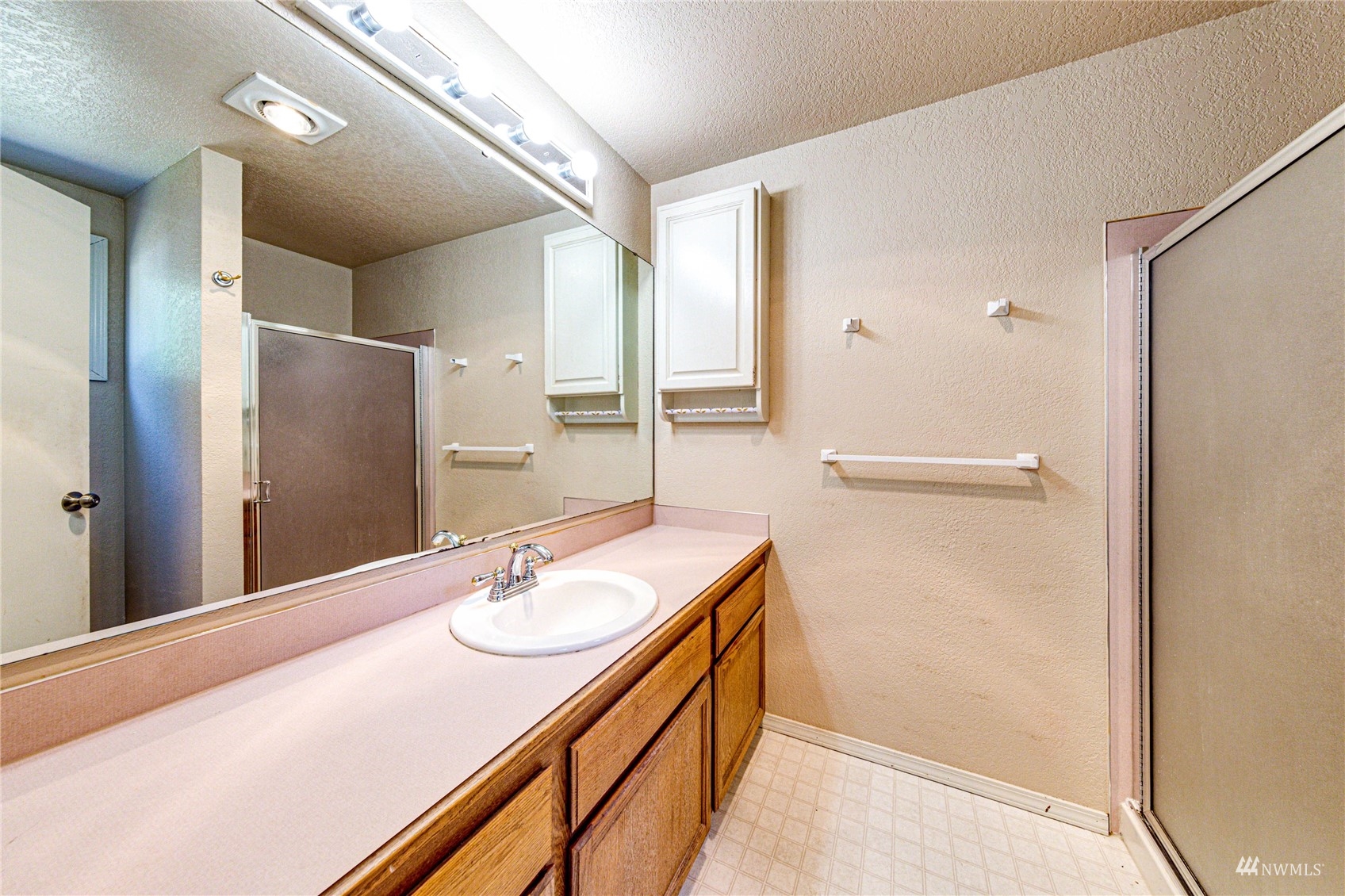 1027 233rd Place Southwest Bothell, WA 98021 - Photo 15 of 27 a bathroom with a sink double vanity and a mirror