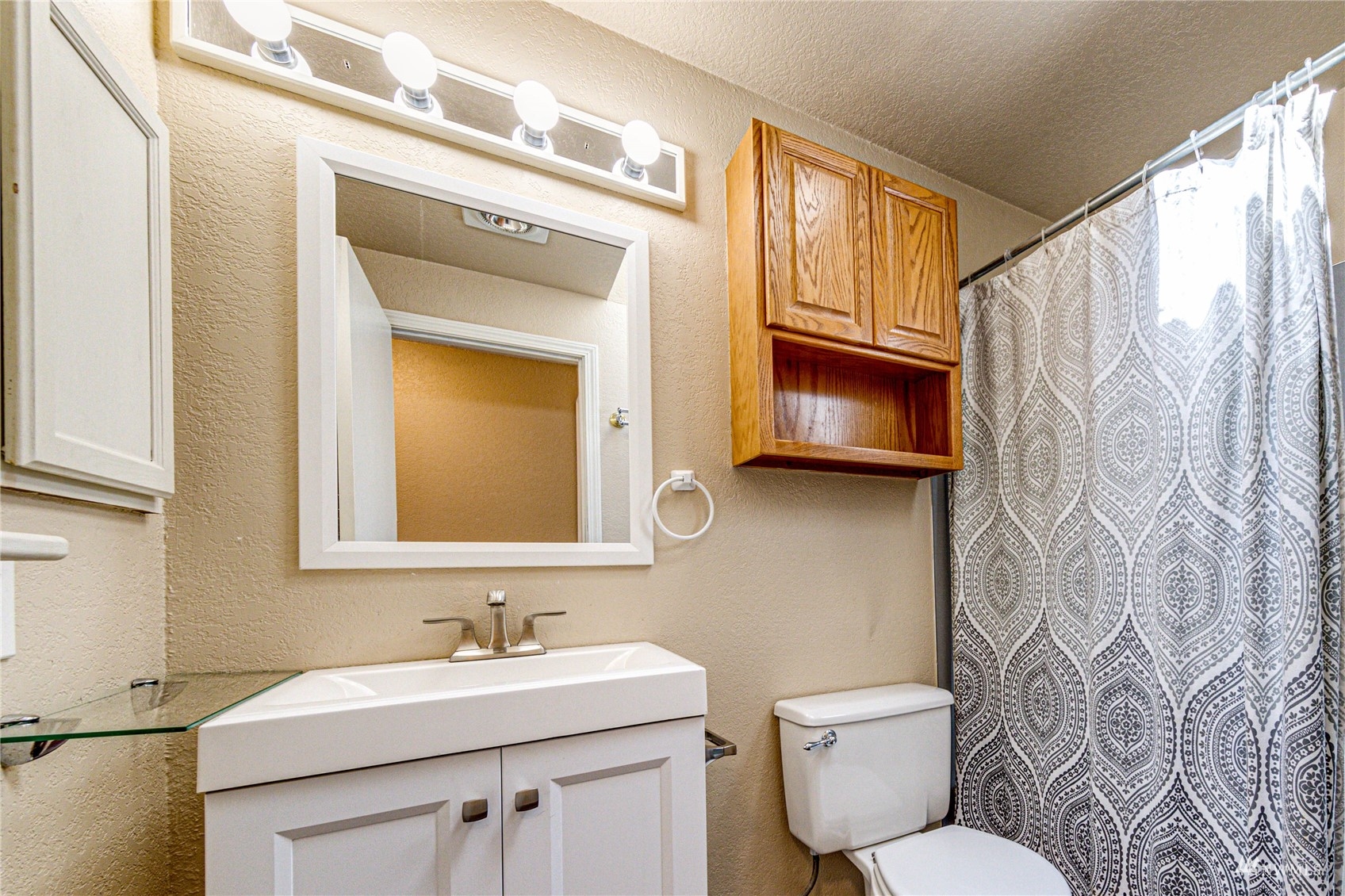 1027 233rd Place Southwest Bothell, WA 98021 - Photo 17 of 27 a bathroom with a toilet a sink and a mirror