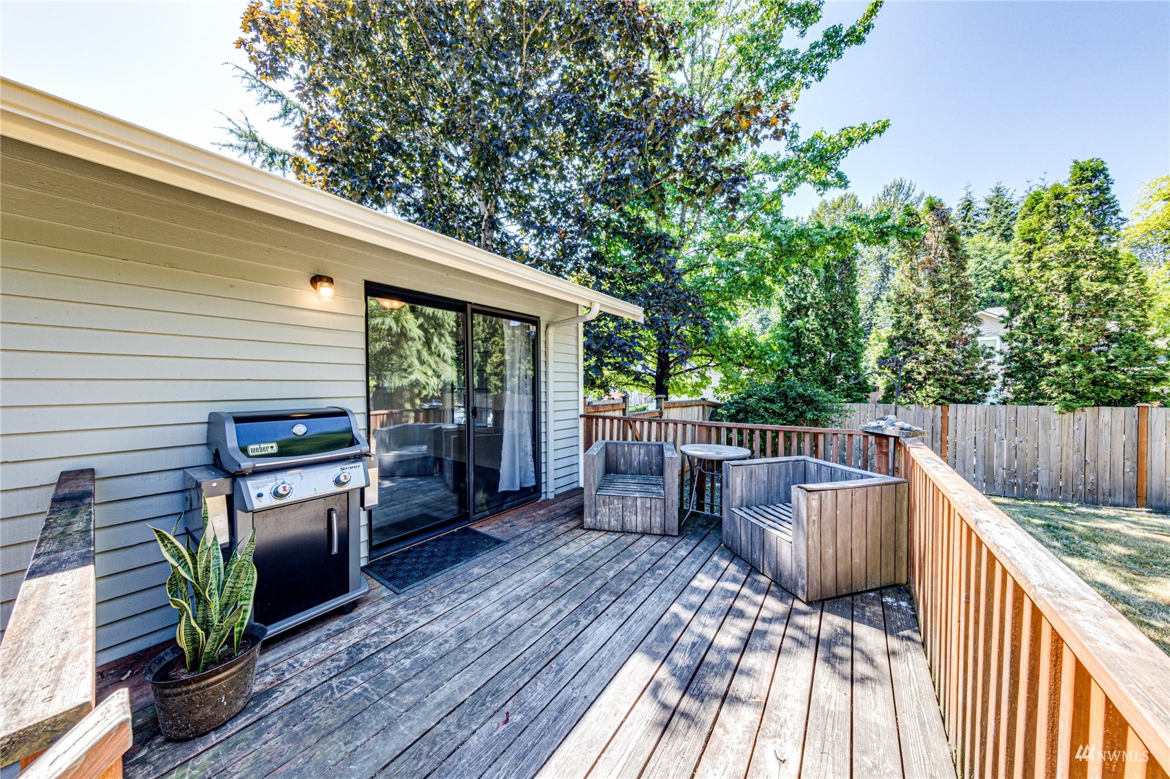 1027 233rd Place Southwest Bothell, WA 98021 - Photo 19 of 27 a view of a deck with wooden floor and outdoor seating
