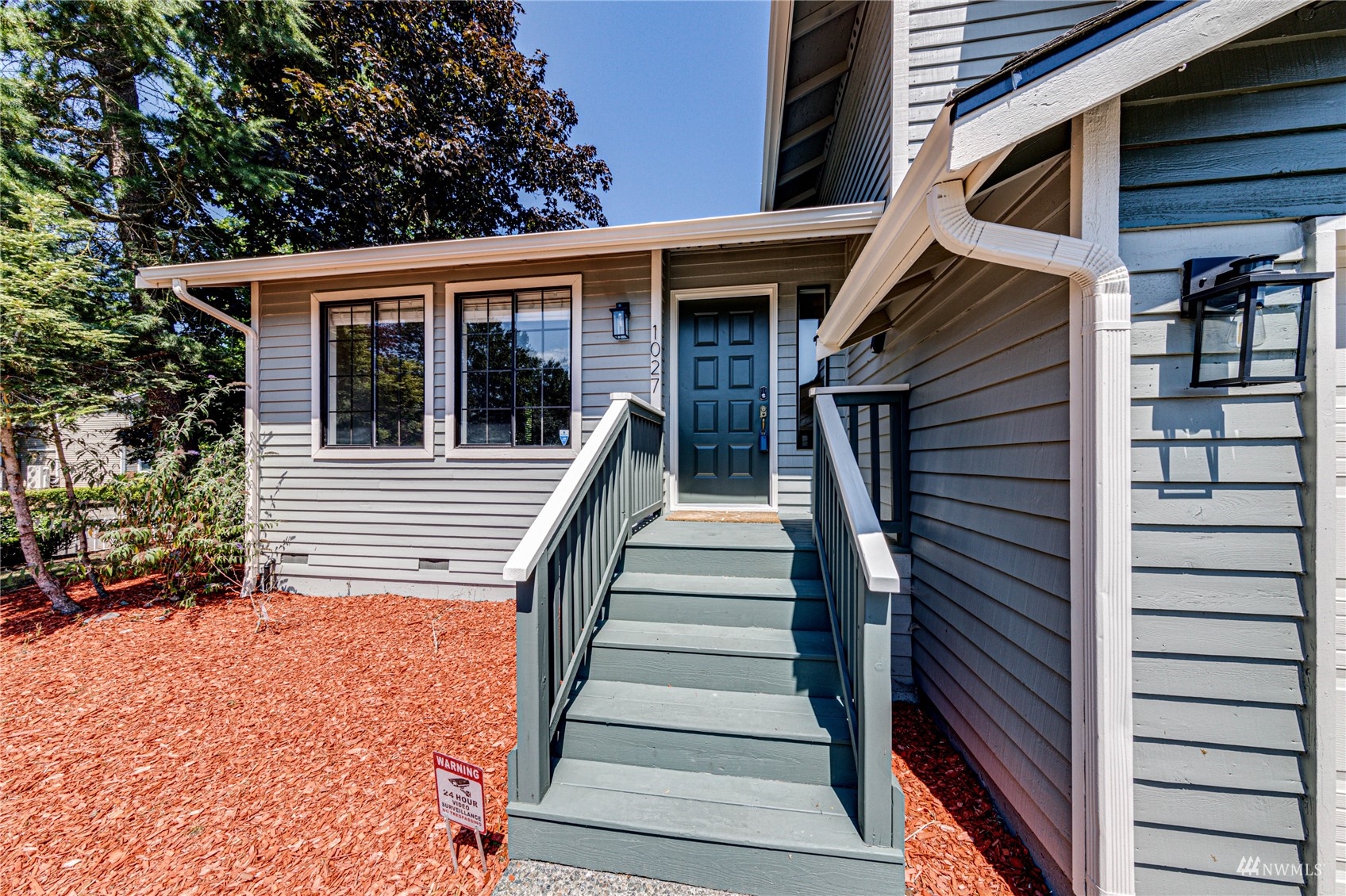 1027 233rd Place Southwest Bothell, WA 98021 - Photo 2 of 27 a view of a house with wooden stairs and a window