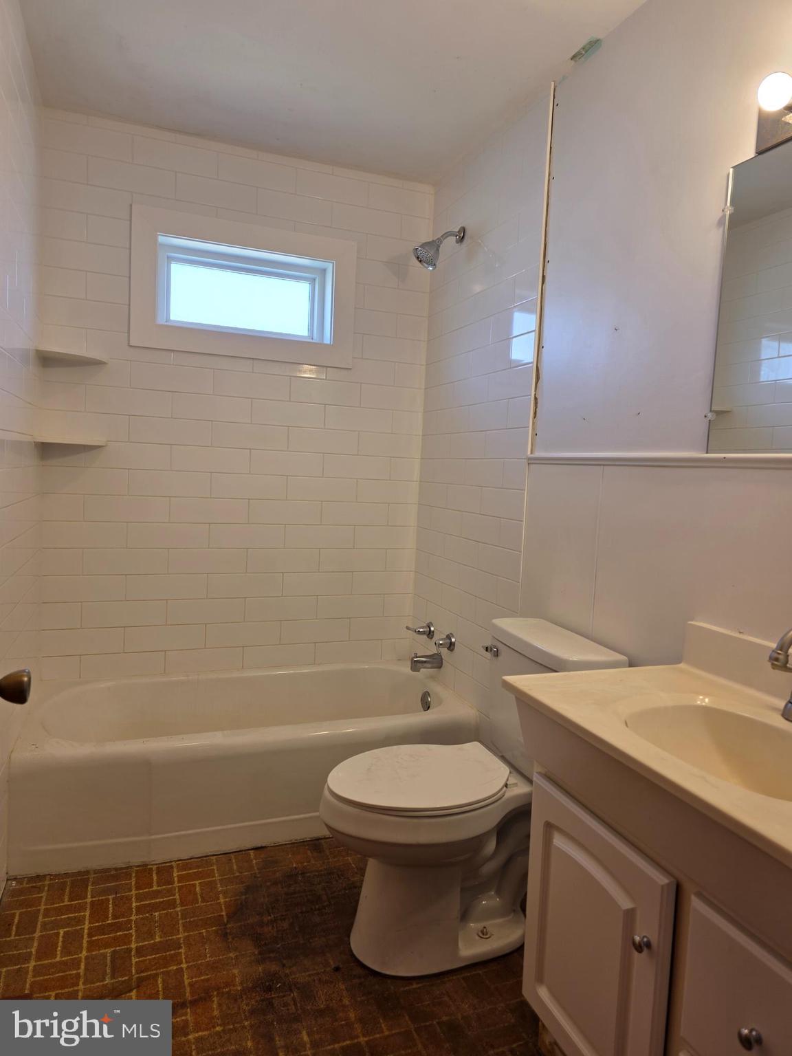697 West Denneys Road Dover, DE 19904 - Photo 13 of 16 a bathroom with a toilet a sink and bathtub
