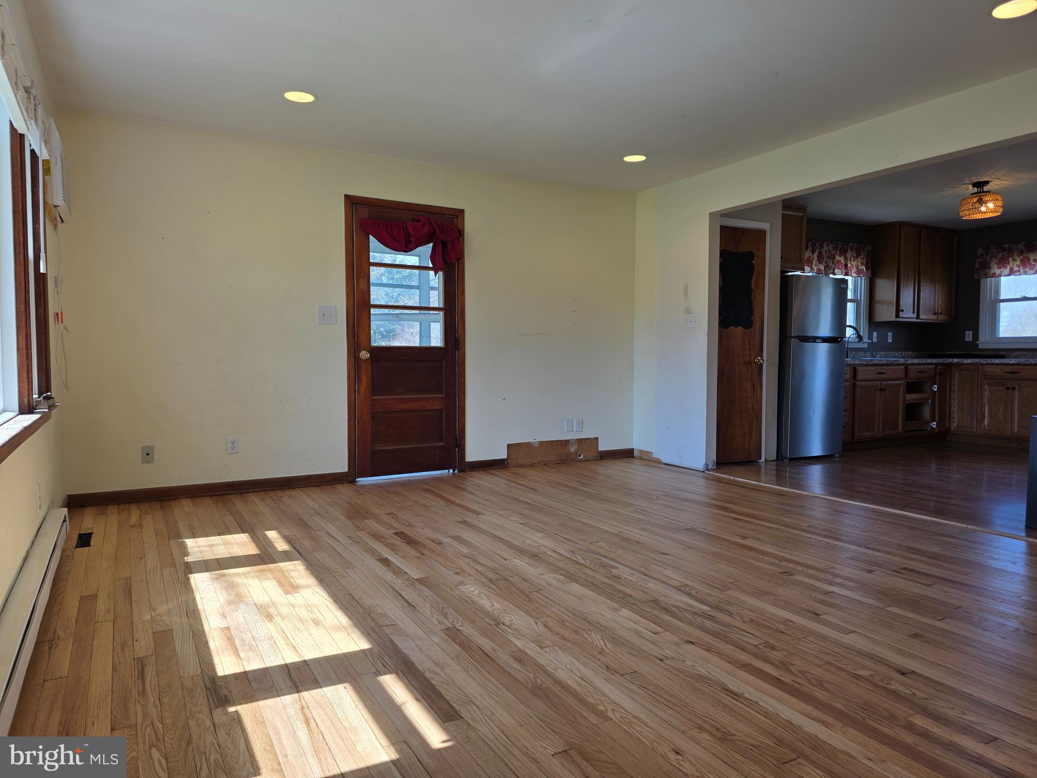 697 West Denneys Road Dover, DE 19904 - Photo 4 of 16 a view of hallway with wooden floor and kitchen view