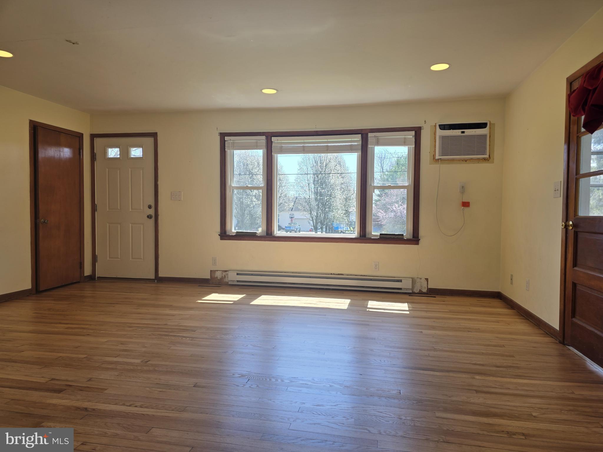 697 West Denneys Road Dover, DE 19904 - Photo 6 of 16 an empty room with wooden floor and windows