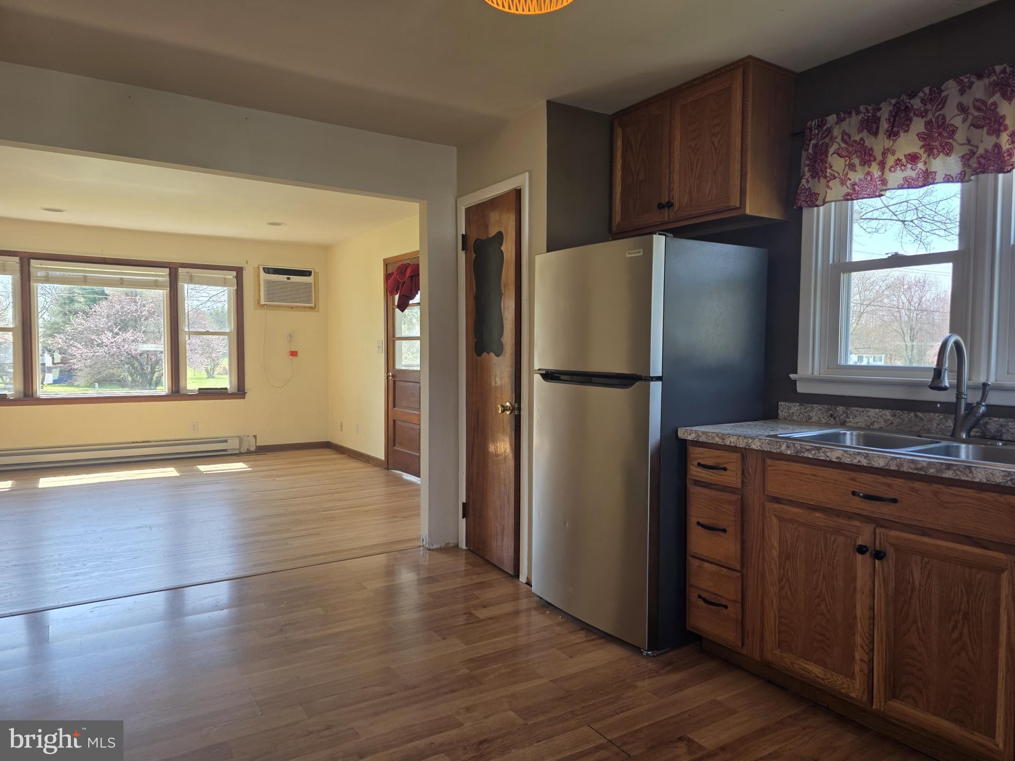 697 West Denneys Road Dover, DE 19904 - Photo 7 of 16 a kitchen with granite countertop a refrigerator and a sink