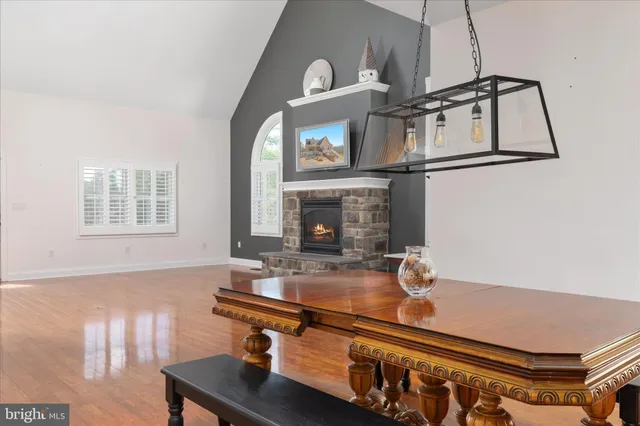 a kitchen with stainless steel appliances granite countertop a stove and a wooden floor