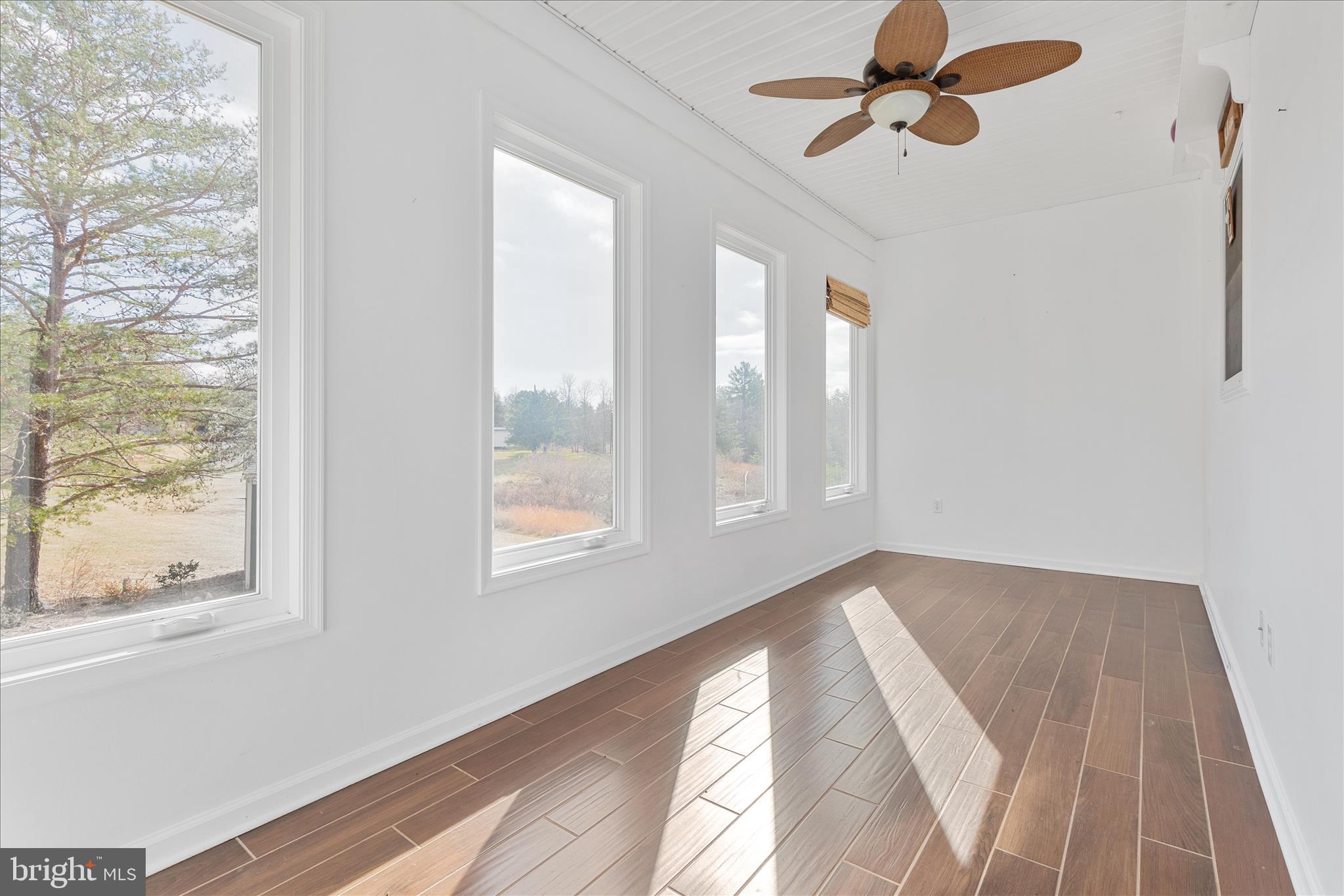 882 Liberty Furnace Road Edinburg, VA 22824 - Photo 17 of 47 a view of empty room with wooden floor and fan