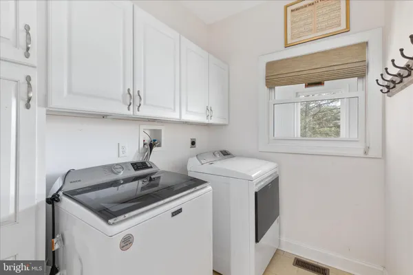 a view of entryway and dining room with wooden floor