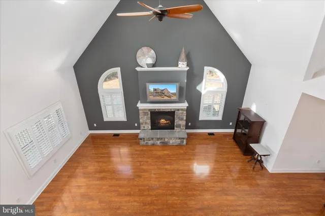 a view of a livingroom with a fireplace a window and a fireplace