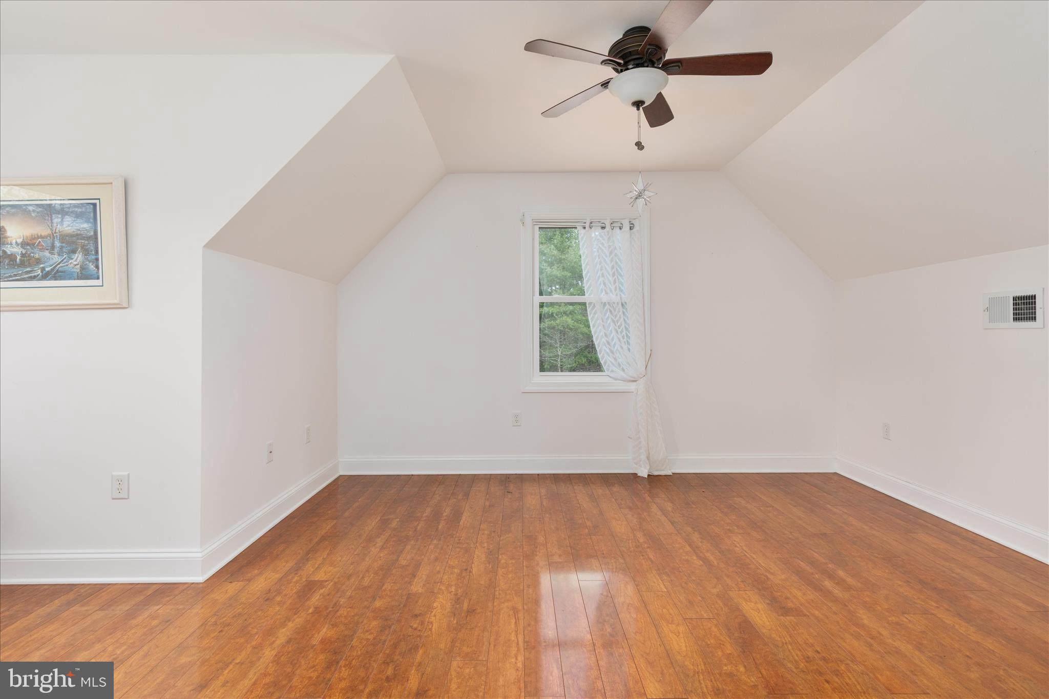 882 Liberty Furnace Road Edinburg, VA 22824 - Photo 33 of 47 an empty room with a window and a ceiling fan