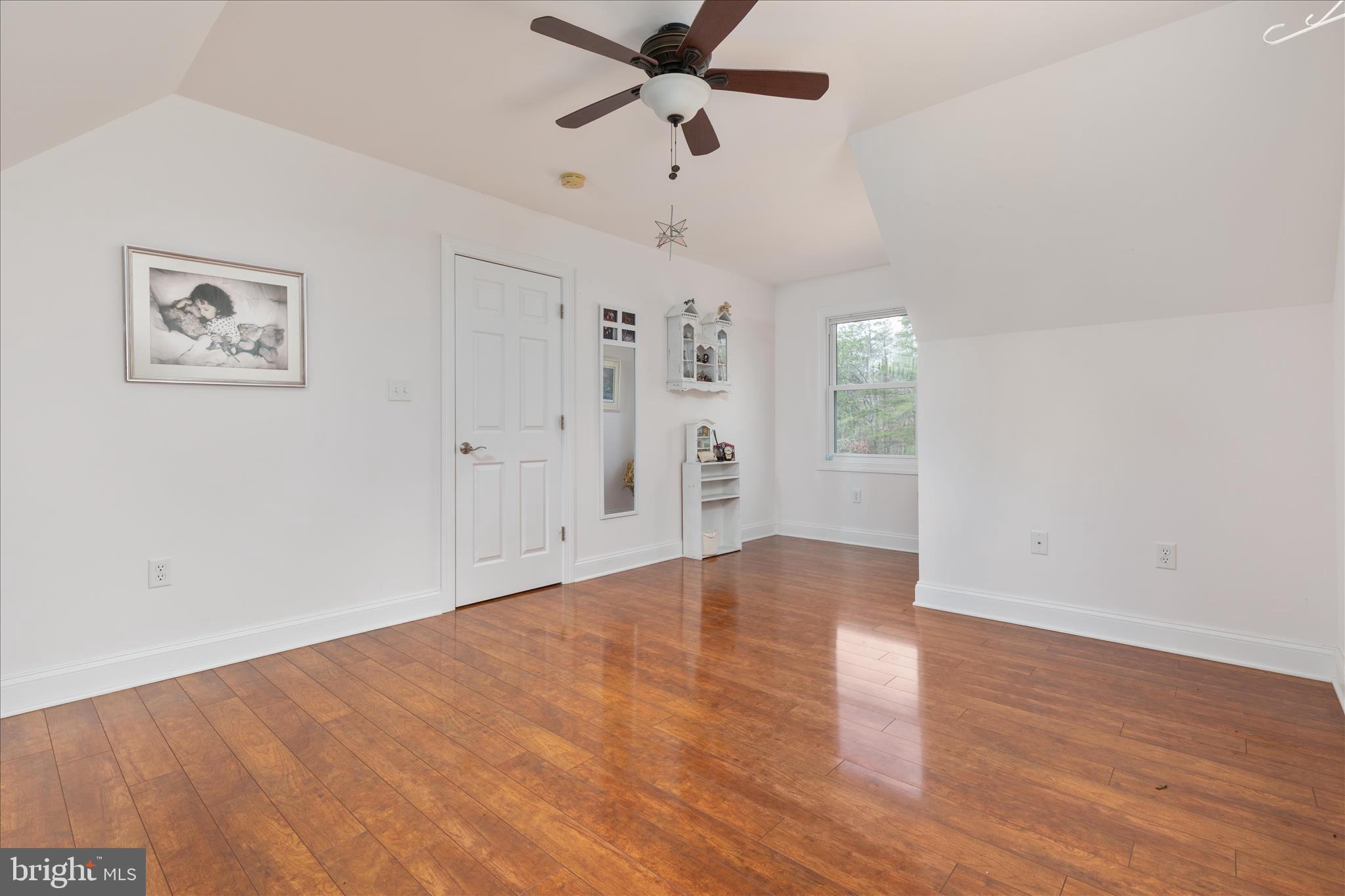 882 Liberty Furnace Road Edinburg, VA 22824 - Photo 35 of 47 an empty room with wooden floor ceiling fan and windows