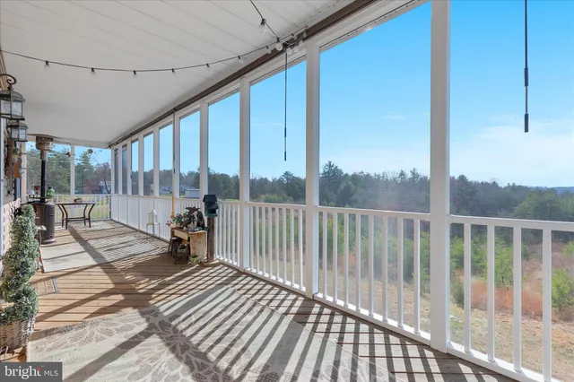 a view of a balcony with a table and chairs