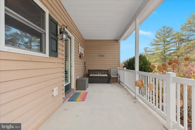 a view of a house with a small yard and wooden floor and fence