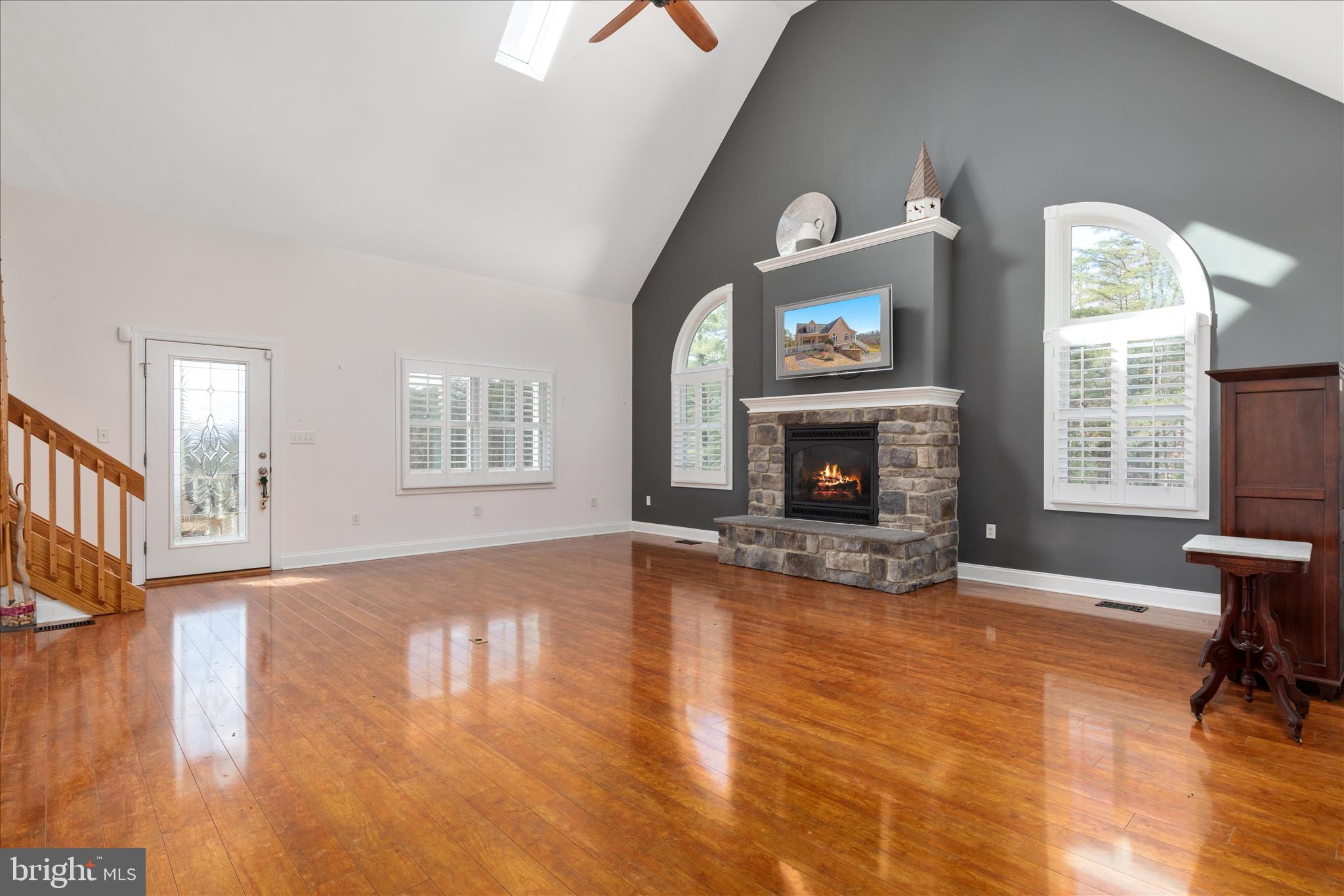882 Liberty Furnace Road Edinburg, VA 22824 - Photo 5 of 47 a view of an empty room with wooden floor fireplace and a window