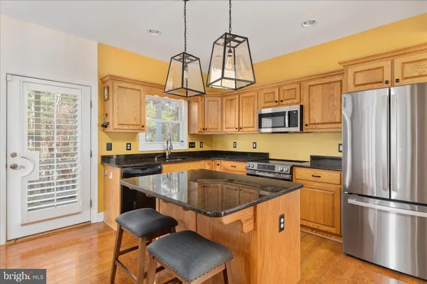 a kitchen with stainless steel appliances a stove a refrigerator and a sink