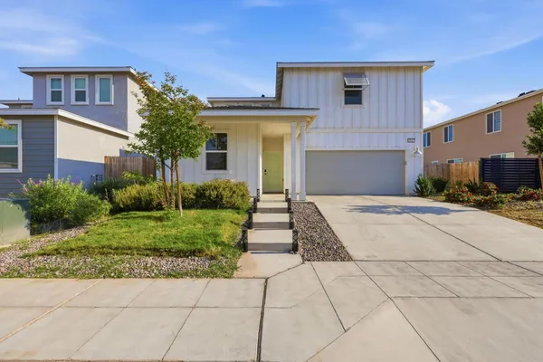 a front view of a house with garden