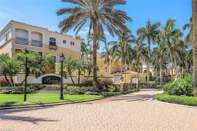 a view of a multi story residential apartment building in a yard