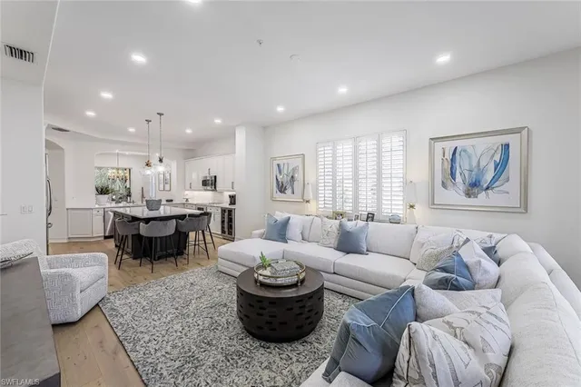 a living room with furniture and a painting