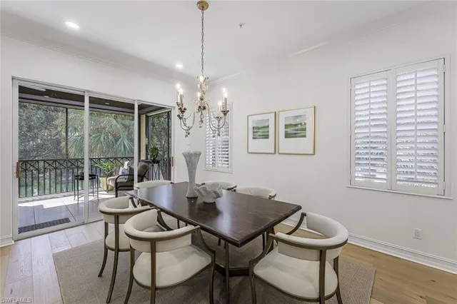a view of a dining room with furniture wooden floor and chandelier