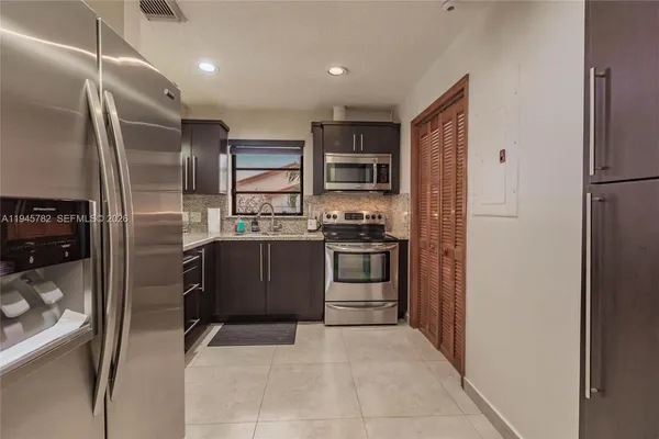 a kitchen with stainless steel appliances a refrigerator and a stove