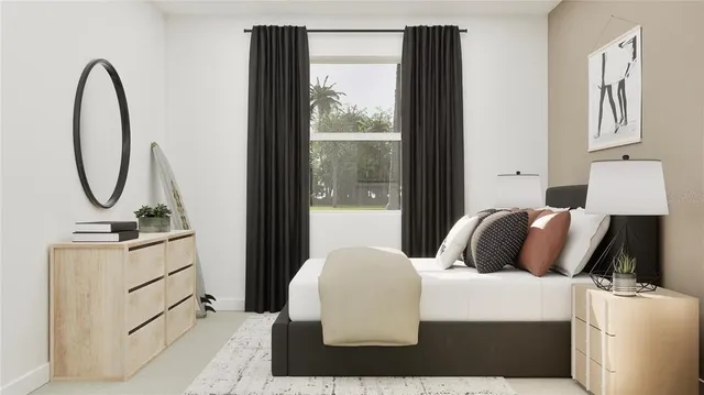 a bedroom with a bed a mirror and lamp