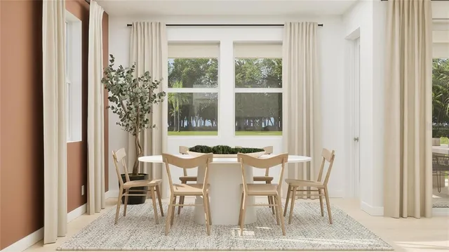 a view of a dining room with furniture and a window