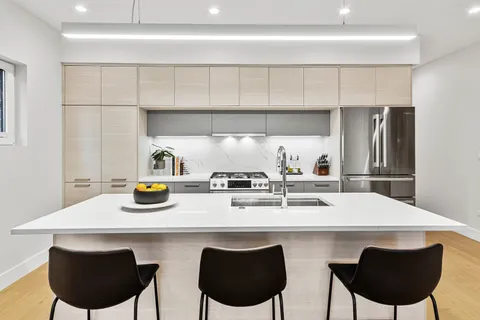 a kitchen with a table chairs stove and cabinets