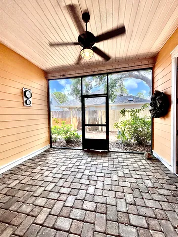 a view of a porch with a table and chairs