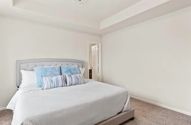 a bedroom with a bed and a night stand