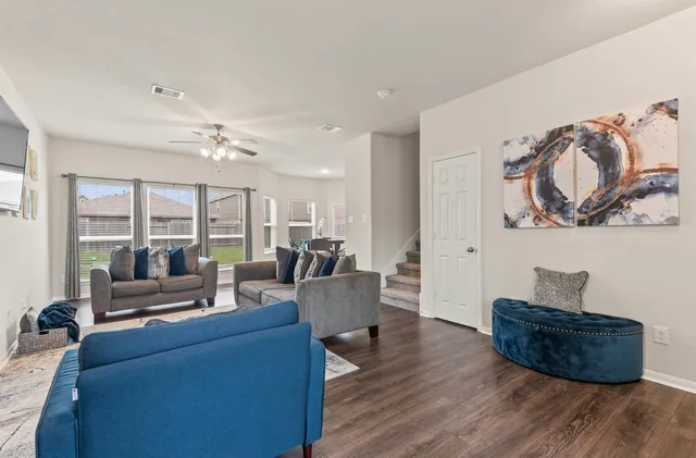 a living room with furniture and a large window