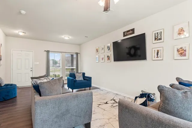 a living room with furniture and a flat screen tv