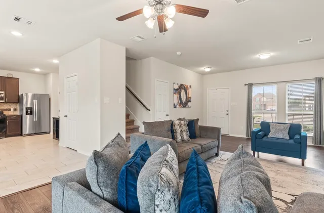 a living room with furniture and a large window