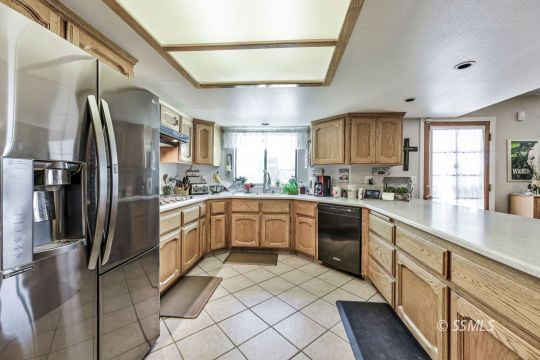 1213 Andrea Court Ridgecrest, CA 93555 - Photo 18 of 50 a kitchen with stainless steel appliances granite countertop a refrigerator a sink dishwasher a stove and white cabinets with wooden floor