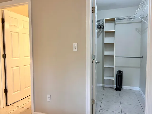a view of walk in closet with empty racks